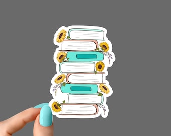 May include: A stack of six books with a white background and a sticker border. The books are decorated with sunflowers and other floral elements. The books are stacked in a tower with the top book being the smallest and the bottom book being the largest.
