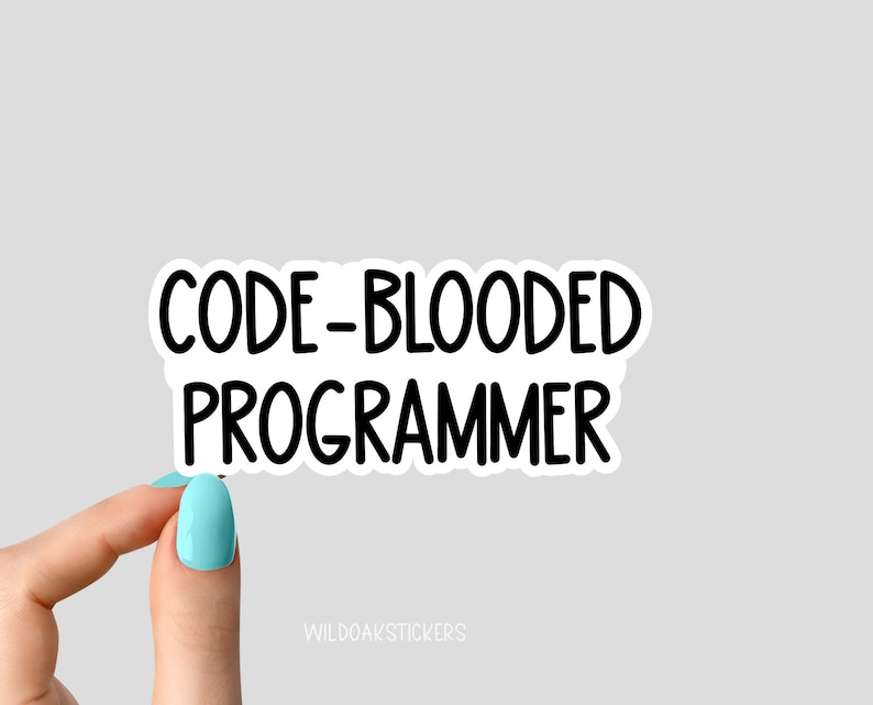 May include: White sticker with black text that reads "CODE-BLOODED PROGRAMMER". A hand is holding the sticker.