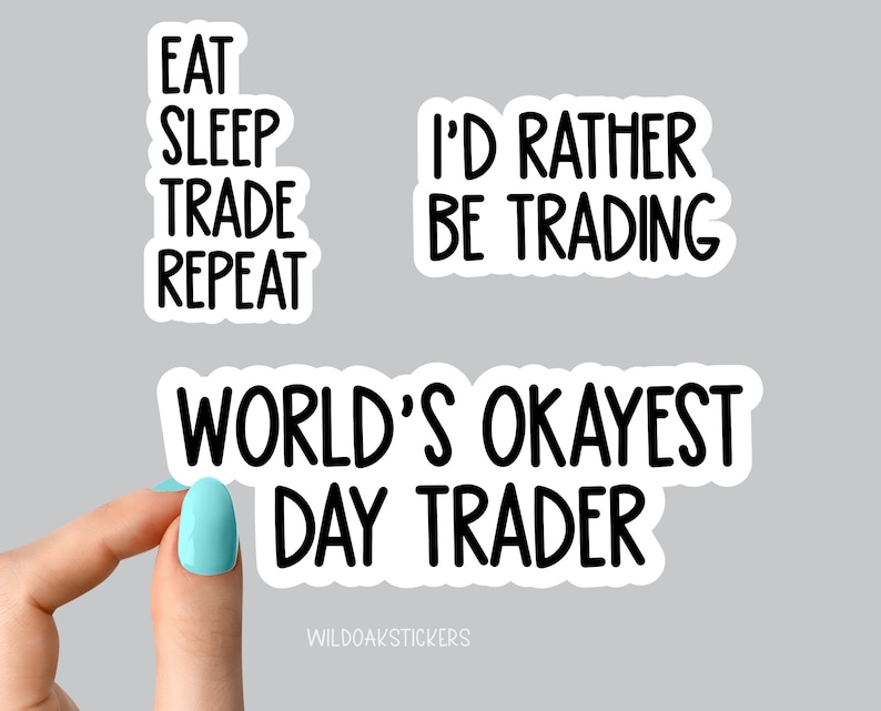 May include: Three white stickers with black text. The first sticker says "Eat Sleep Trade Repeat". The second sticker says "I'd Rather Be Trading". The third sticker says "World's Okayest Day Trader".