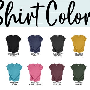 May include: A selection of t-shirt colors, including solid white, solid black, heather navy, dark grey heather, heather mustard, heather dust, heather true royal, heather aqua, heather charity pink, heather maroon, heather forest, and heather autumn.