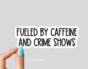 May include: White sticker with black text that reads "Fueled by caffeine and crime shows".