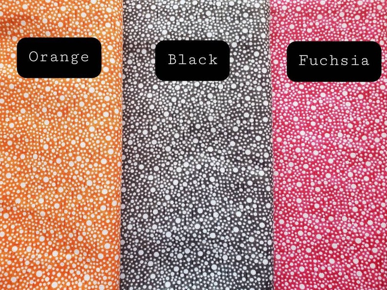 May include: Three fabric swatches with white polka dots on different colored backgrounds. The swatches are labeled "Orange", "Black", and "Fuchsia".
