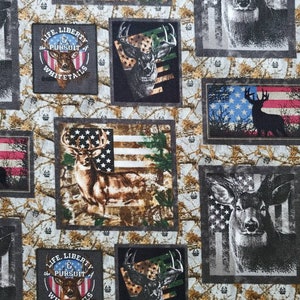 May include: A fabric featuring a repeating pattern of deer imagery, American flags, and the text "LIFE, LIBERTY & the PURSUIT of WHITETAILS." The deer are depicted in various styles, including silhouettes and detailed portraits, with a camouflage background.
