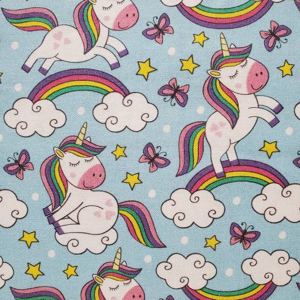 Unicorn Dance, 100% Cotton Fabric. Cartoon Image Unicorns on Sky Blue with Butterflies, and Stars. By the Half Yard. 18" long x 43" wide.