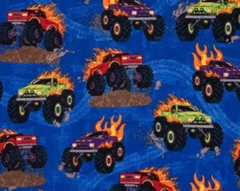 Monster Trucks. Cotton Fabric. Flaming Trucks in Purple, Red, & Lime Green on Royal Blue with Tire Tracks. By the Half Yard, 18"x43".