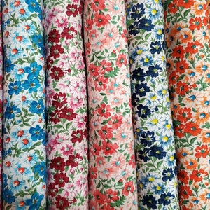 May include: A collection of 10 different fabric swatches with a white background and a floral pattern in various colors, including purple, pink, blue, red, orange, and yellow.