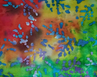 Batik Abstract Pebbles of Purple and Blue on a Tie Dye Background of Green, Red, Yellow and Orange. Cotton Fabric, 18" long x 42" wide.