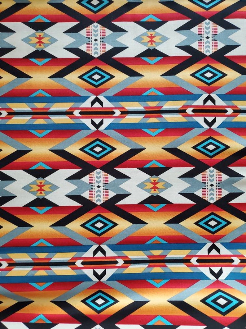 May include: A colorful fabric with a geometric pattern in shades of red, orange, yellow, blue, black, and white. The pattern is reminiscent of Native American designs.
