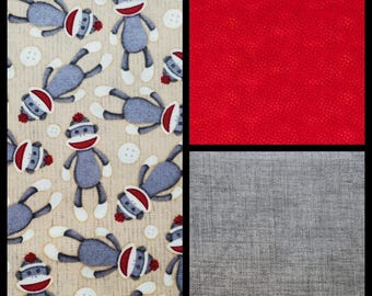 Sock Monkey, or Coordinating Prints. Cotton Fabric. Beige, Gray, and Red. By the Half Yard, 18" long x 43" wide.