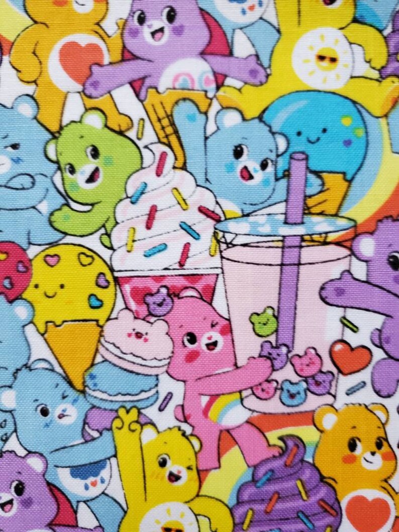May include: A colorful fabric with a repeating pattern of cartoon bears, ice cream cones, and other sweet treats. The bears are all different colors and have different expressions. The background is white with a rainbow pattern.
