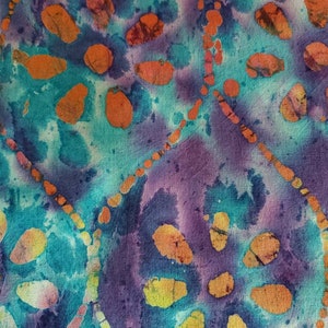 Batik Abstract Pebbles of Yellow, Orange, and Red Creating a Daisy  Flower on a Purple and Turquoise Background. Cotton Fabric, 18&quot; x 42&quot;.