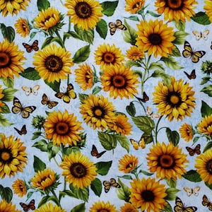 Sunflowers and Butterflies. Cotton Fabric. Scattered Sunflowers & Butterflies on a Blue Mottled Background. By the Half Yard, 18&quot; x 43&quot;.