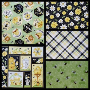 May include: A collage of fabric patterns featuring bees and floral designs. Includes honeycomb shapes with text like "Bee Happy" and "Home Sweet Honey", daisies on black, plaid, and a panel with beehives and bees.