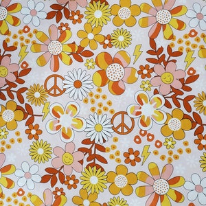 May include: A pink and white floral print fabric with yellow, orange, and brown flowers. The fabric features peace signs and lightning bolts.