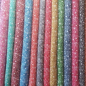 May include: A collection of 20 fabric swatches with a white polka dot pattern on a variety of colored backgrounds. The colors include purple, pink, teal, red, maroon, blue, gray, orange, yellow, green, and brown.