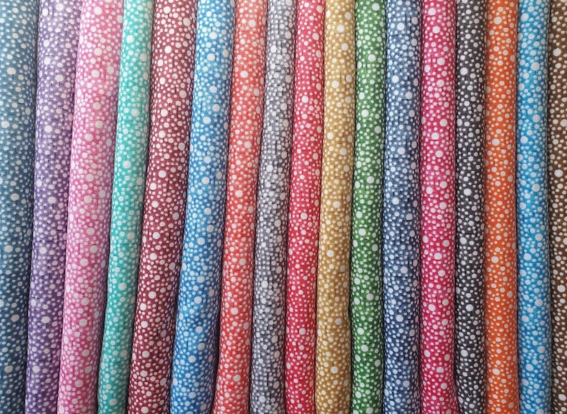 May include: A collection of 20 fabric swatches with a white polka dot pattern on a variety of colored backgrounds. The colors include purple, pink, teal, red, maroon, blue, gray, orange, yellow, green, and brown.