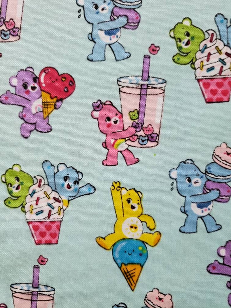 May include: A light blue background with a repeating pattern of colorful cartoon bears enjoying various sweet treats. The bears are holding ice cream cones, cupcakes, and bubble tea.