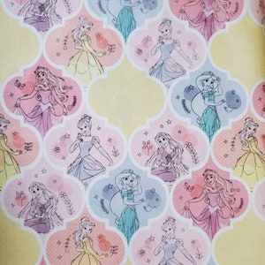 May include: A white background with a repeating pattern of Disney princesses in various poses. Each princess is surrounded by a light pink, light blue, or yellow frame. The princesses are all wearing their signature dresses and have a watercolor effect.