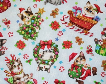 Vintage Christmas Kitties. Cotton Fabric. Kitties on a Pale Blue Background with Sleighs, Toys, Stockings. By the Half Yard, 18"x43" wide.