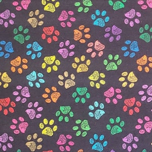 Paw Prints. 100% Cotton Fabric. Brightly-colored, Sketched, Kitty Cat Paw Prints on Black. By the Half Yard. 18" long x 43" wide.