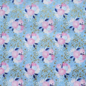 May include: A blue fabric with a pink and white floral pattern and gold glitter accents.