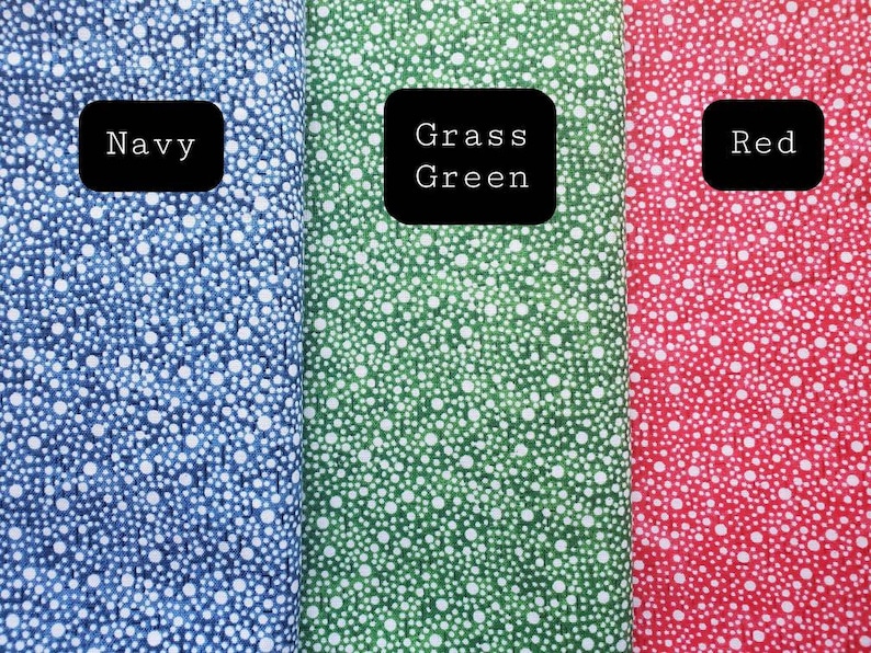 May include: Three fabric swatches with white polka dots on a blue, green, and red background. The swatches are labeled "Navy", "Grass Green", and "Red".