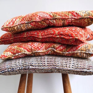 Green, red and orange seat pads (40x40cm) made from 100% recycled cotton vintage saris.