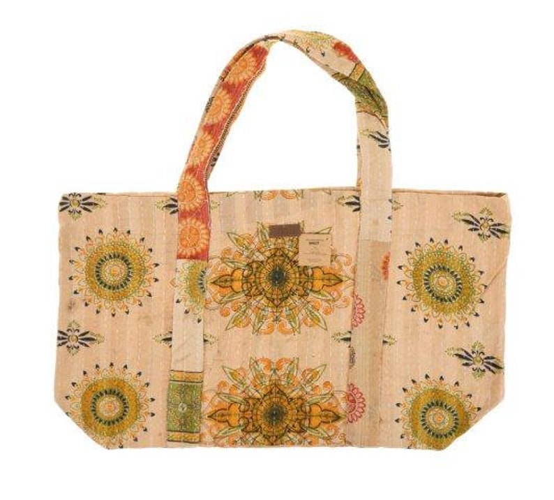 May include: A beige tote bag with colorful floral patterns and patchwork details. The bag has two long straps and a large main compartment.