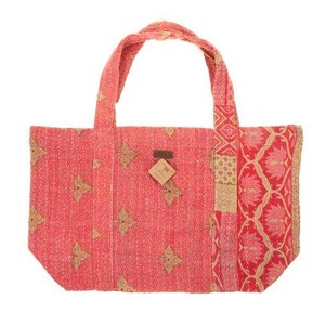 May include: A red and gold patchwork tote bag with a floral pattern. The bag has two handles and a small brown tag attached to the front.