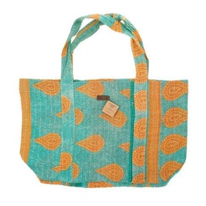 May include: A turquoise and orange tote bag with a paisley pattern. The bag has two long straps and a small tag with the word "OX" on it.
