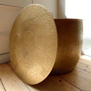 Hand hammered storage tables, made from recycled aluminium, available in two sizes large (52x40cm), medium (41x34cm).  Colour antique gold.