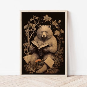 May include: A framed art print featuring a bear reading a book. The bear is depicted in a sepia tone, surrounded by foliage, with open books at its feet. The artwork has a vintage, storybook aesthetic.