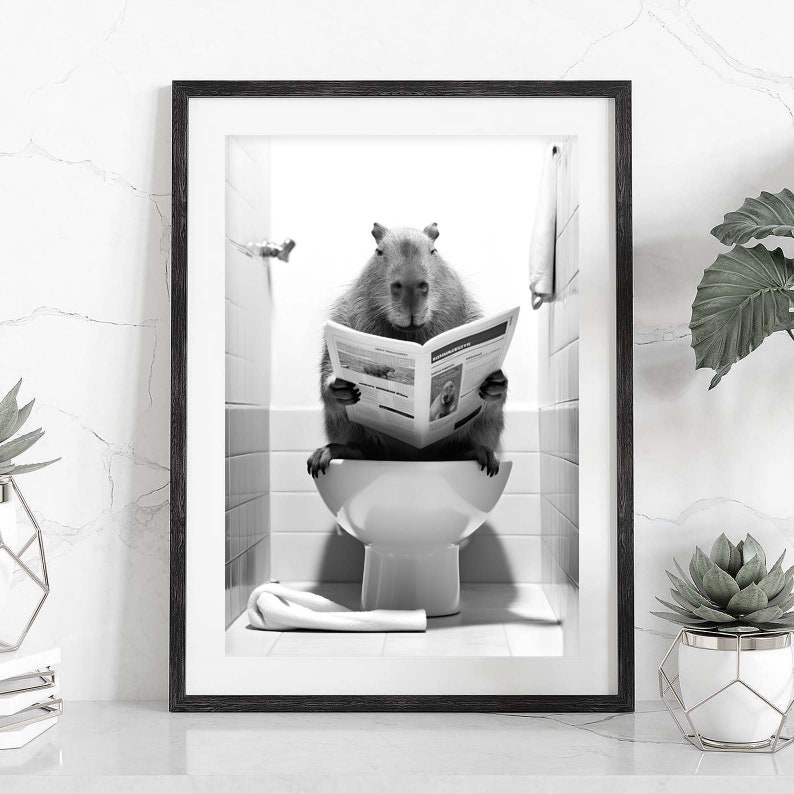 May include: A black and white photo of a capybara sitting on a toilet and reading a newspaper. The capybara is in a bathroom with white tile walls and a white toilet.