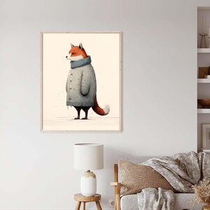 May include: A framed wall art print featuring an illustration of a red fox standing in profile. The fox is wearing a long, light gray, button-down knit cardigan with a high, ribbed blue-gray collar. The background is a solid, light cream color.