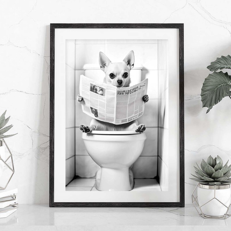 May include: A black and white photo of a small dog sitting on a toilet and reading a newspaper. The dog is wearing a collar and has a serious expression on its face.