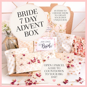 May include: A cardboard box containing seven small, beige, patterned parcels for a bride's 7-day advent countdown. The set includes a card labelled Here Comes The Bride, scattered pink rose petals, and text stating 16 items to choose from.