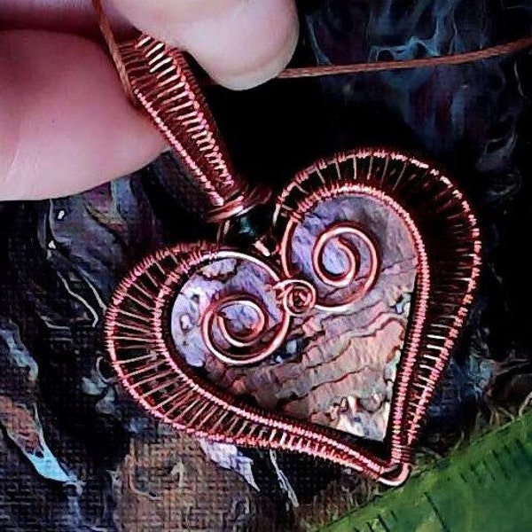 Natural raw Abalone Shell Heart Pendant. Just look at these colors of purple, pink, green, blues, and yellow. Weaved in pure copper.
