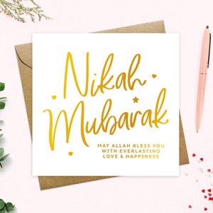 May include: A white card with gold lettering that says "Nikah Mubarak" and "May Allah bless you with everlasting love & happiness".