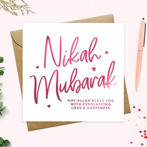 May include: A white card with pink calligraphy that reads "Nikah Mubarak" and the text "May Allah bless you with everlasting love & happiness".