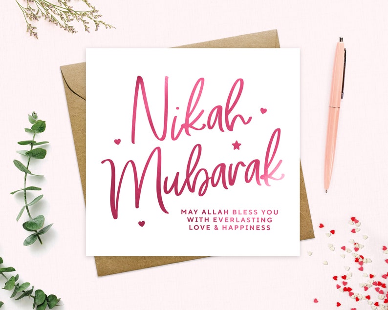 May include: A white card with pink calligraphy that reads "Nikah Mubarak" and the text "May Allah bless you with everlasting love & happiness".