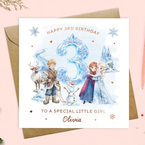 May include: A square birthday greeting card featuring a large blue ice-themed number 3, illustrations of characters including a reindeer, a snowman, and two figures in winter attire, with the text HAPPY 3RD BIRTHDAY, TO A SPECIAL LITTLE GIRL, and Olivia.