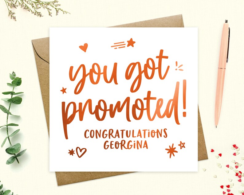 May include: A white card with a copper foil design that says "You got promoted! Congratulations Georgina".