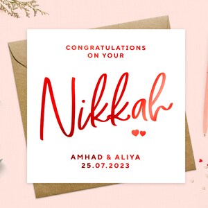 May include: White card with red text that says "Congratulations on your Nikkah" with two small red hearts below the text. The card also includes the names "Ahmad & Aliya" and the date "25.07.2023".