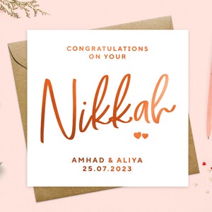 May include: A white card with the words "Congratulations on your Nikkah" in copper foil lettering. The names "Ahmad & Aliya" and the date "25.07.2023" are also in copper foil lettering.