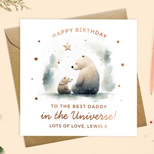 May include: A birthday card featuring a watercolour illustration of two bears, one large and one small, under a starry sky. The card reads "HAPPY BIRTHDAY TO THE BEST DADDY in the Universe! LOTS OF LOVE, LEWIS X". Includes a peach pen.