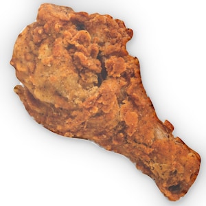 May include: A single piece of fried chicken, golden brown with a crispy, textured exterior. The chicken drumstick is isolated against a white background, showcasing its seasoned, savory appearance. The image highlights the details of the fried coating.