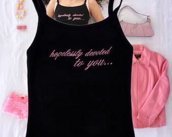 May include: Black tank top with pink straps and the text "hopelessly devoted to you..." embroidered in pink.