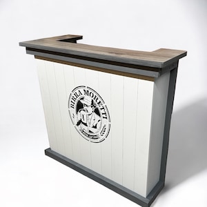 May include: A white wooden bar counter with a grey top and a black and white logo that says "Birra Moretti" with a man in a hat drinking a beer.