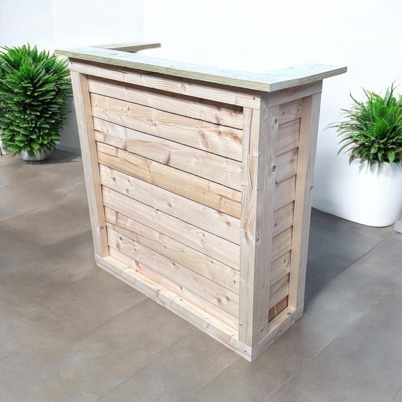 May include: A wooden bar counter with a natural finish. The counter has a rectangular top and a simple design with horizontal planks.