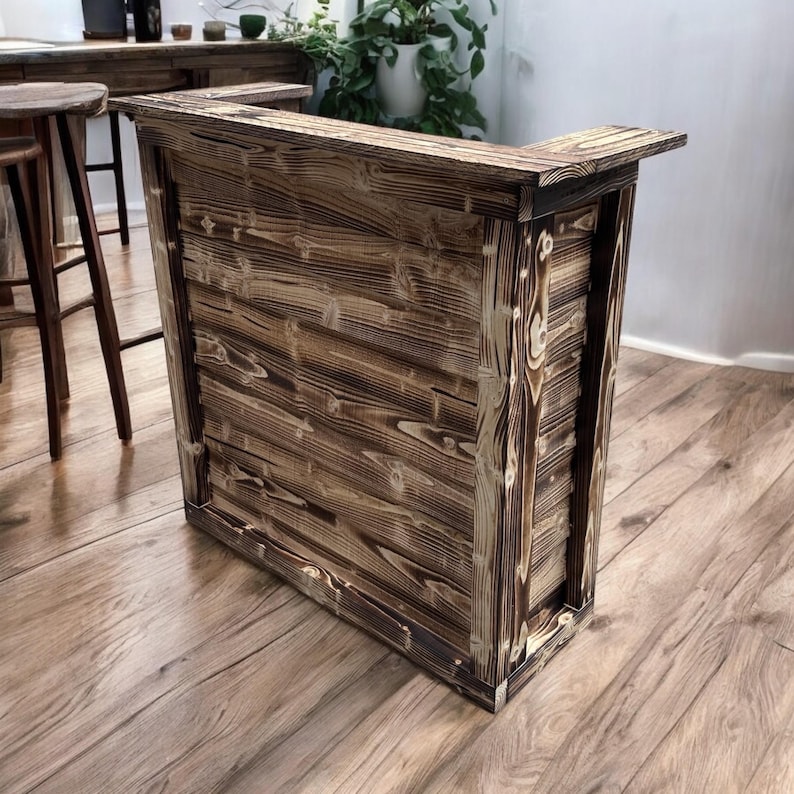 May include: A rustic wooden bar counter with a dark brown finish and a natural wood grain pattern. The counter has a rectangular shape and a simple design.